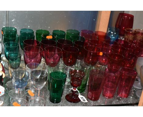 A COLLECTION OF COLOURED DRINKING GLASSES, to include a single ruby etched glass with rough pontil mark, four small red glass