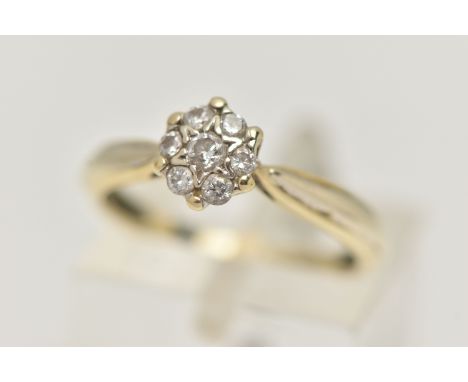 A 9CT GOLD DIAMOND CLUSTER RING, small circular cluster set with seven round brilliant cut diamonds, claw settings, pinched s