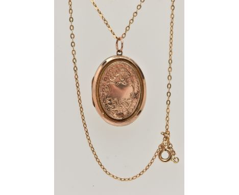 AN EARLY 20TH CENTURY 9CT GOLD FRONT AND BACK LOCKET WITH YELLOW METAL CHAIN, the oval locket with embossed foliate detail, s