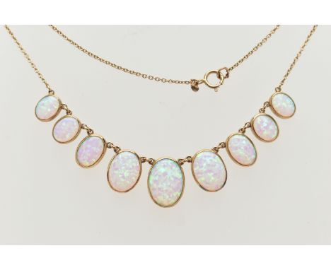 A YELLOW METAL SYNTHETIC OPAL PENDANT NECKLACE, designed as a series of nine graduated synthetic opals, each collet set, stam