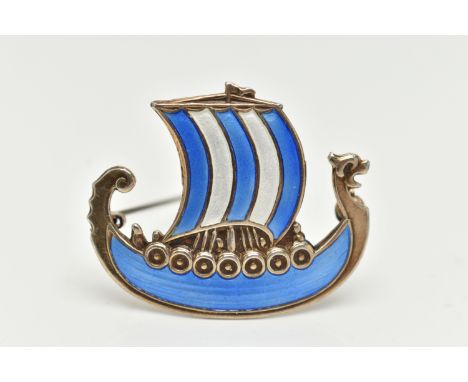 A WHITE METAL NORWEGIAN ENAMEL BROOCH, in the form of a Viking ship, decorated with blue and white enamel, signed to the reve