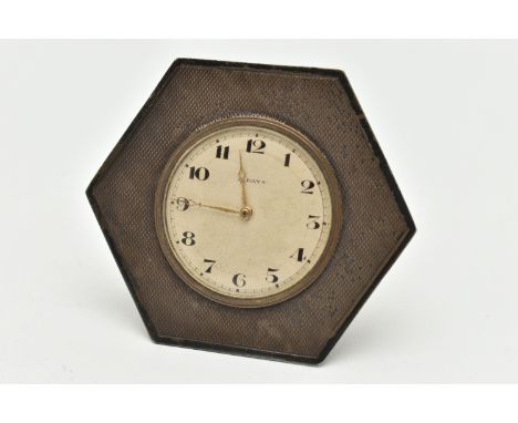 A SILVER 8 DAY BEDSIDE TABLE CLOCK, hexagonal form, engine turned pattern, with a round silvered dial, signed '8 Days', Arabi