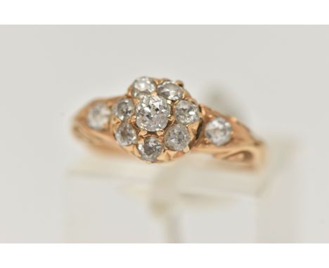 A YELLOW METAL DIAMOND CLUSTER RING, circular cluster set with eight old cut diamonds, flanked with two old cut diamond set s