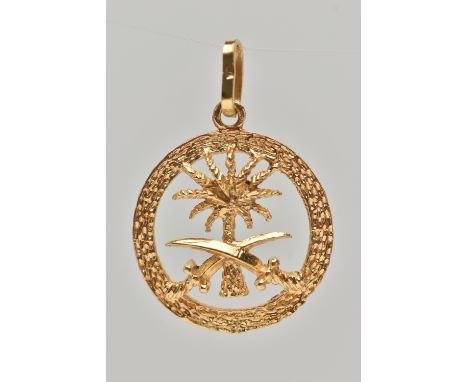 A YELLOW METAL PENDANT, of a circular open work form, depicting a palm tree and two swords, with a textrued surround, fitted 