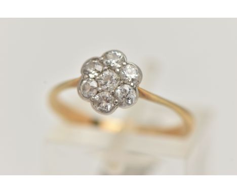 A YELLOW METAL DIAMOND CLUSTER RING, flower shape cluster set with seven old cut diamonds, estimated total diamond weight 0.4