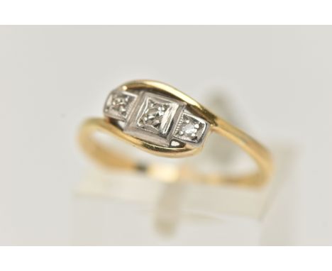 A THREE STONE DIAMOND RING, three single cut diamonds, prong set in white metal, leading on to a yellow metal bypass yellow m