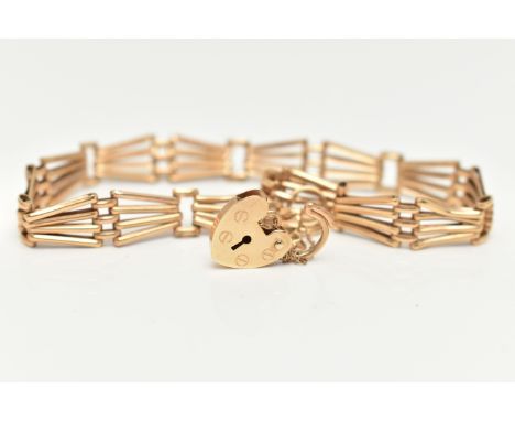 A 9CT YELLOW GOLD BRACELET WITH PADLOCK CLASP, the plain polished abstract design four row gate bracelet, with padlock clasp 
