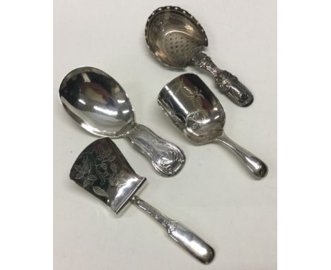 Four silver caddy spoons including an Irish example. Approx. 37 grams. Est. £30 - £40.