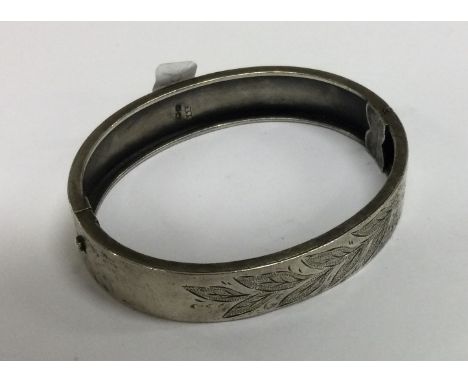 A silver engraved bangle. Birmingham. Approx. 15 grams. Est. £20 - £30.