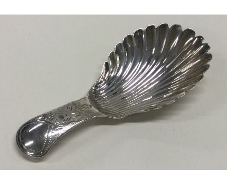 A silver caddy spoon with engraved handle and fluted bowl. Birmingham 1822. By Joseph Taylor. Approx. 7 grams. Est. £40 - £60
