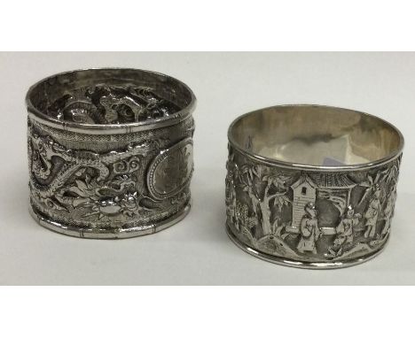 Two heavy Chinese silver napkin rings decorated with figures. Approx. 48 grams. Est. £20 - £30.