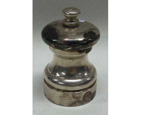A novelty silver pepper grinder. Approx. 114 grams. Est. £30 - £50.
