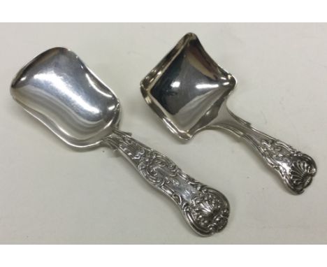 A Queen's pattern silver caddy spoon. London 1857. By SH&DC. Together with a King's pattern example. Birmingham 1838. By GU. 