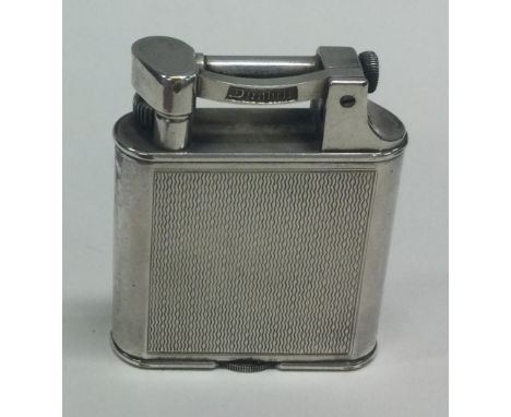 DUNHILL: An engine turned silver plated lighter. Est. £30 - £40.