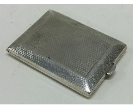 A novelty engine turned silver cigarette case. London 1929. Approx. 38 grams. Est. £30 - £50.