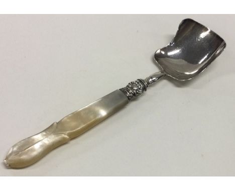 A silver caddy spoon with MOP handle. Birmingham 1853. By GU. Approx. 21 grams. Est. £30 - £40.