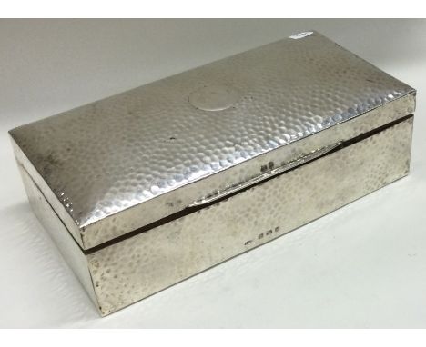 A silver rectangular cigar box with hammered decoration. Birmingham 1908. By Henry Wilkinson. Approx. 733 grams of gross weig