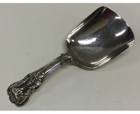 A silver caddy spoon with hourglass pattern handle. Birmingham 1824. By Joseph Taylor. Approx. 11 grams. Est. £30 - £40.