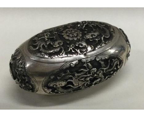 An early chased Chinese silver hinged box. Approx. 58 grams. Est. £30 - £50.