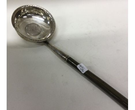 A large silver toddy ladle inset with coin. 1789. Approx. 53 grams. Est. £30 - £50.