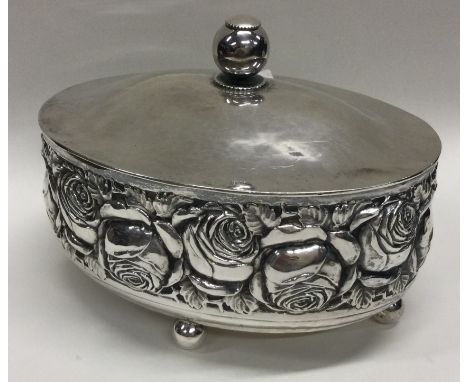A German silver chased tea caddy embossed with flowers. Marked to base. Approx. 329 grams. Est. £250 - £300.