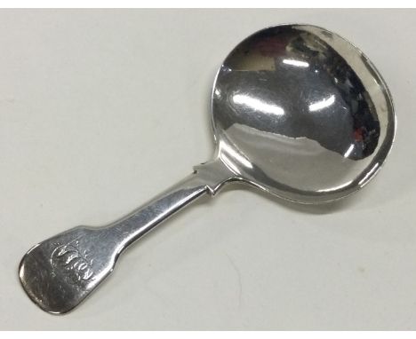 A fiddle pattern silver caddy spoon with engraved initials. London 1822. By GW. Approx. 11 grams. Est. £20 - £30.