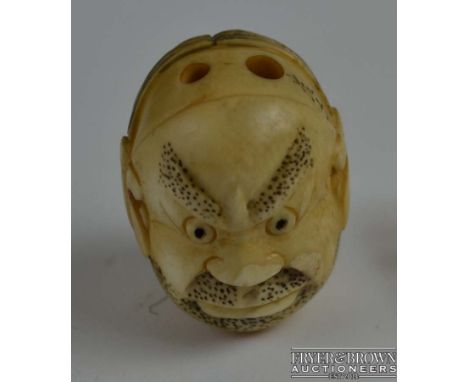 A Japanese ivory netsuke, double faced, depicting happiness and anger, a child's face to the base, signed, c1920