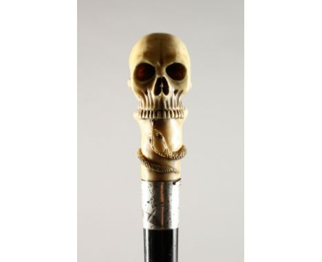 A CARVED IVORY SKULL WALKING STICK with silver band. 2ft 8ins long.