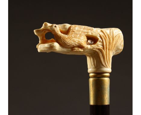 A BONE HANDLED WALKING STICK, carved as a bird and tree stump. 35ins long.