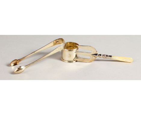 A PAIR OF GEORGIAN BRIGHT CUT SUGAR TONGS, serviette ring and ham fork.