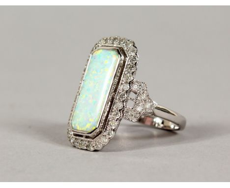 A 9CT GOLD, OPAL AND DIAMOND RING.