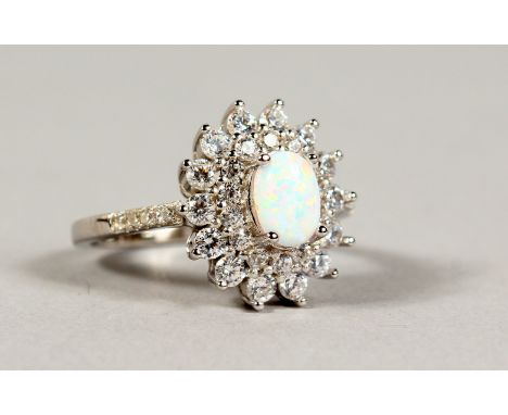 A SILVER, OPAL AND CZ CLUSTER RING.