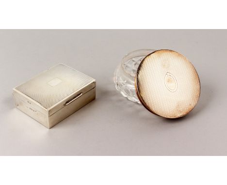 AN ENGINE TURNED SILVER TOP CIRCULAR GLASS POWDER BOX, 3.5ins diameter, Birmingham 1953, and AN ENGINE TURNED CIGARETTE BOX, 