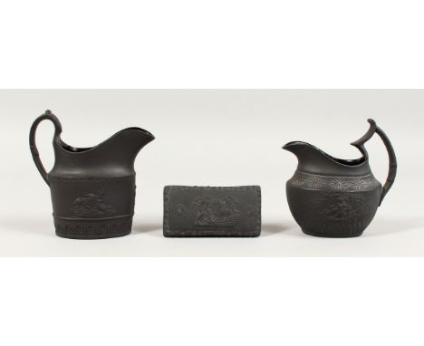 A SMALL WEDGWOOD BLACK BASALT TRINKET BOX, 3.5ins long, and two milk jugs (3).