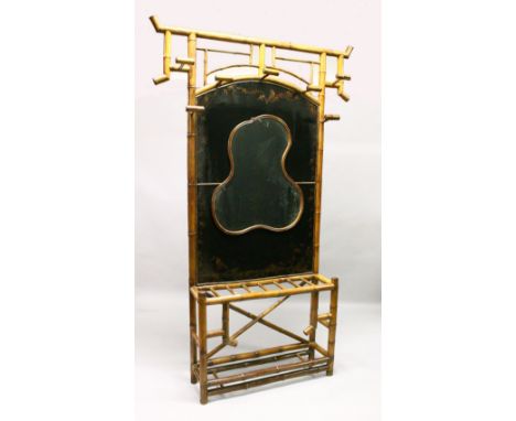 A VERY GOOD 19TH CENTURY BAMBOO AND LACQUER HALL STAND, with seven coat/hat hooks, decorative black lacquer back panel with s