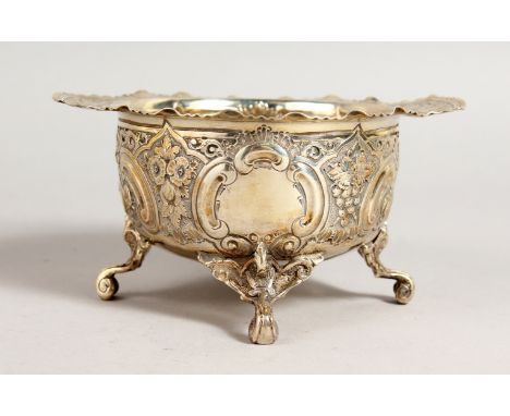 A VICTORIAN TWO-HANDLED SUGAR BASIN, with repousse decoration, on four curving legs. Sheffield 1891.  Maker: Keeley Brothers.