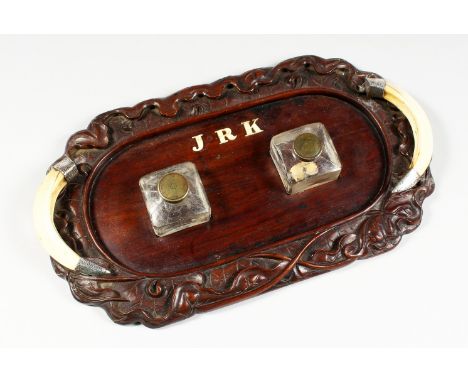 AN INTERESTING 19TH CENTURY DESK STAND, with carved Chinese rosewood base, boars tusk handles with Indian silver mounts, a pa