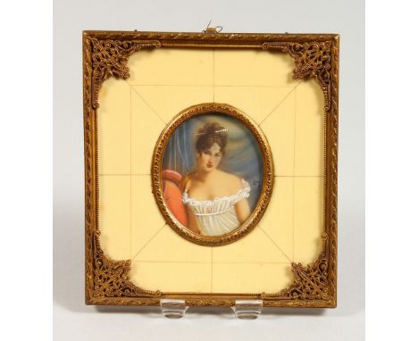 AN OVAL PORTRAIT MINIATURE, young lady wearing a white dress, in an ivorine and gilt metal frame. 5.25ins x 4.75ins.