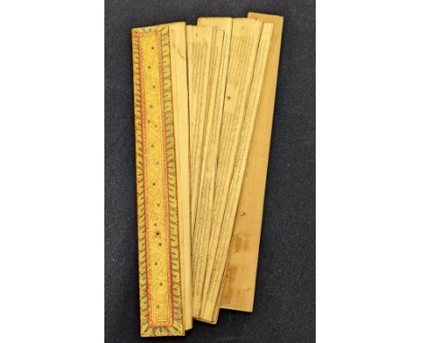 A late 19th/ early 20th century Sinhalese palm leaf manuscript with painted wooden covers, Sri Lanka, L.39cm
