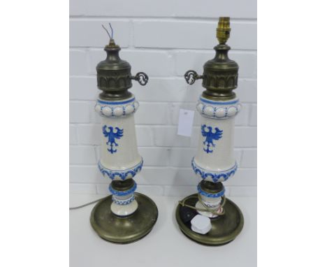 A pair of craquelure glazed pottery and metal table lamp bases with eagle motifs in relief (2) 57cm high