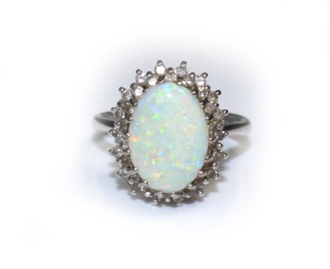 A modern 18ct white gold, opal and diamond oval cluster ring, the oval cabochon white opal measuring approximately 14.5mm X 1