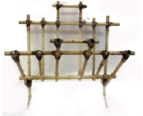 A unusual cream enamelled metal faux bamboo Canterbury, first half 20th century, in Regency style, with ropetwist bindings, 4