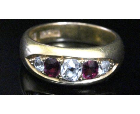 An Edwardian gold, ruby and diamond five stone gypsy ring, the three graduated old-cut diamonds approximately 0.45cts total, 