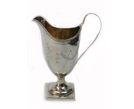 A George III silver helmet shape cream jug, Stephen Adams, London 1793, with beaded rim, bright cut engraved with floral swag