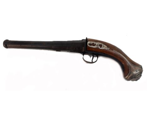 A flintlock pistol, first half 18th century, the walnut stock with silver mounts, centred by a mask, 34cm across (af).