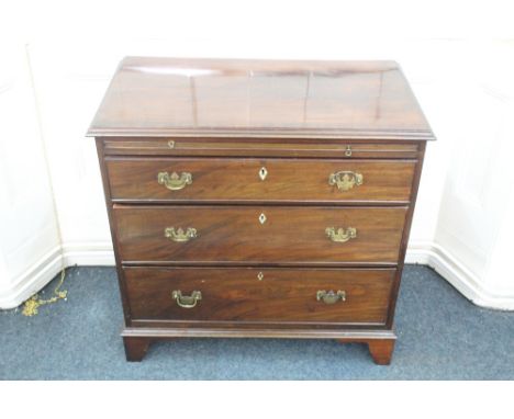 A George III mahogany chest, altered, the moulded rectangular top above a brushing slide and three long drawers with ivory lo