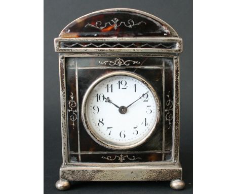 A George V silver and tortoiseshell pique cased miniature timepiece, William Comyns, London 1911, with arched top and bun fee