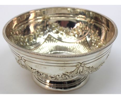 A Victorian circular silver bowl, Edward Hutton, London 1892, with beaded rim, the sides embossed with swags of flowers and f