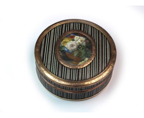 A French gold mounted circular enamel box, late 18th century, the cover inset with an oval painted panel depicting a vase of 