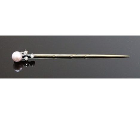 An early 20th century gold, pearl and diamond stick pin, the terminal set with a light-mauve coloured pearl approximately 5.7